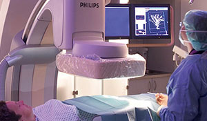 Medici examinând un pacient cu un aparat cu raze X