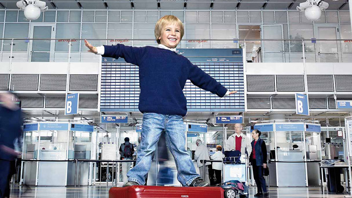 Un copil se joacă într-un terminal de aeroport bine iluminat
